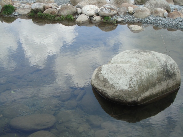Reflections: A certain stop by a river flowing through